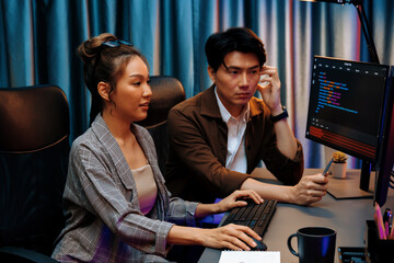 IT developers discussing with point to intelligent website development coder system running data...