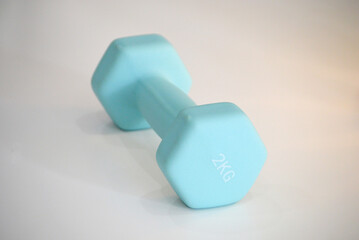 Turquoise Dumbbell on Flat Background 
