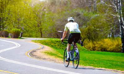 Cyclist ride on the bike path in the city Park