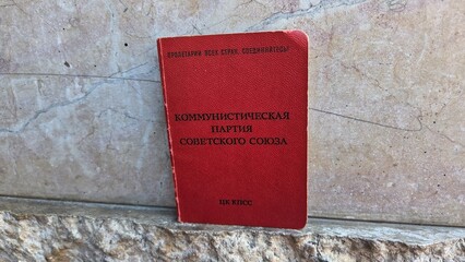 Soviet communist party membership certificate on stone background. Communist Party of the USSR...