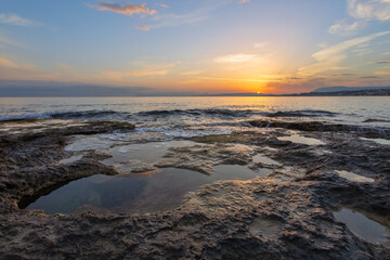 A perfect sunset illuminates the horizon and sky. Beautiful summer sea landscape. Ocean shore....