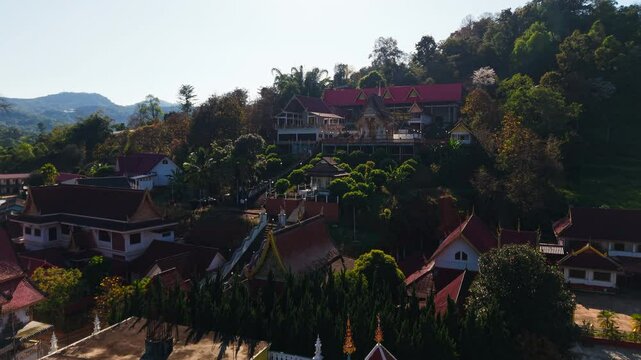 Wat pong yaeng nok buddhist temple, located on a hillside, is shown from various aerial perspectives