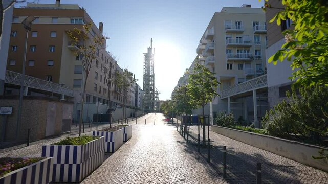 Chamine da Refinaria da GALP seen from residential street in Lisbon Parque das Nacoes with backlight and soft cinematic motion