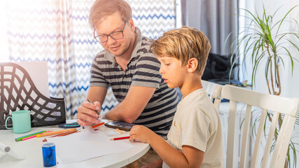 Father and son are doing their homework for school