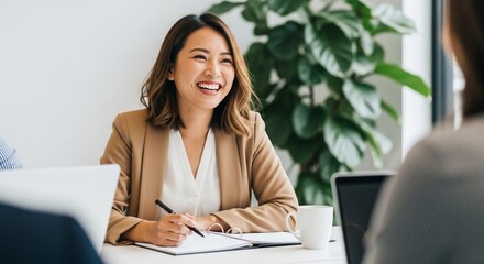 Fototapeta premium Smiling businesswoman takes notes during a meeting with her colleagues