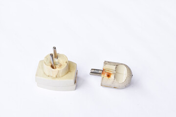 Melted or burned electrical plug white background, electrical socket