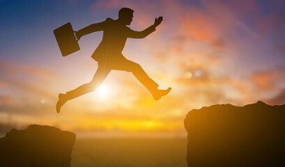 Silhouette of a business with his pocket jump up to another side