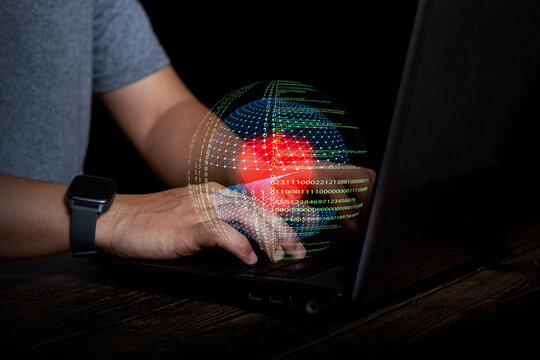 Hacker typing on laptop with global digital sphere and binary code. Concept of cybersecurity, data breach, hacking, and digital threat.