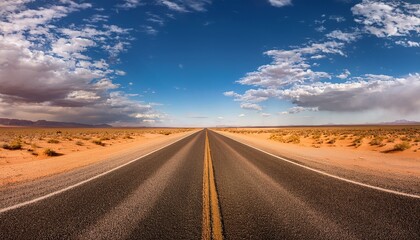 Fototapeta premium expansive desert road stretching into the horizon under a vast open sky with shadows cast by clouds generative ai