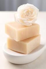Aromatic soap bars and rose on light table