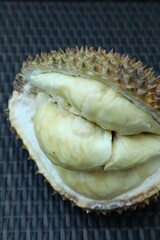 Fresh ripe durian on wicker table, above view