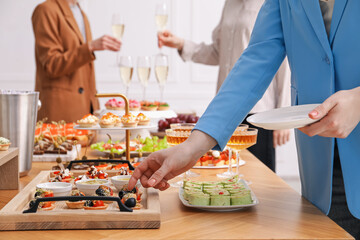 People with different appetizers at buffet, selective focus