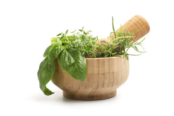 Mortar with pestle and different aromatic herbs isolated on white