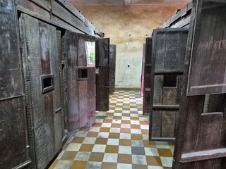 Phnom Penh, Cambodia - 25 June 2025. Wooden solitary confinement cells at Tuol Sleng Genocide...