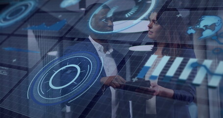Analyzing data on tablet by professionals wearing blazers in office conference room, with holograms