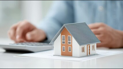 A person is typing on a keyboard in front of a house - Powered by Adobe