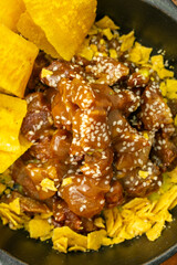 Sticky Pork Bites with Plantain Chips and Tortilla Crumble in Skillet
