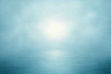 Obraz premium calm sea with soft ripples under a gentle bright sun shining through a misty blue sky, evoking a peaceful and serene atmosphere