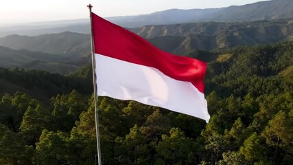 Close-up of Indonesian flag flying proudly in a green highland - Powered by Adobe