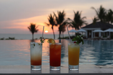 collection of top  famous cocktails beautifully arranged beside tranquil pool or ocean