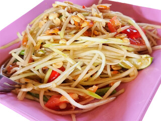 Spicy Thai Green Papaya Salad in Pink Plate on White Background