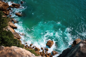 Coastal view of turquoise waves crashing on rocks