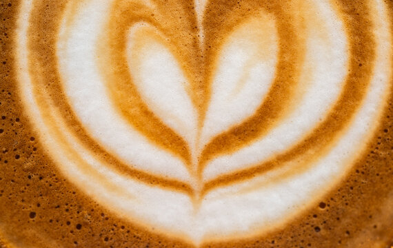 Full frame shot of the surface of hot latte coffee. A latte is a coffee drink made with espresso and steamed milk.