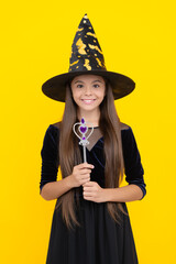 All Hallows party. All Hallows witch. October 31. Teen girl in witch costume hold magic wand. Happy...