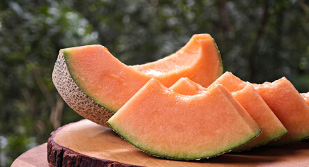 Cantaloupe melon slices on wooden