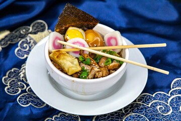 Delicious Ramen Bowl with Toppings Noodles Egg Pork and More. Lámen