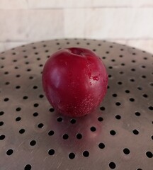 A Single Plum on a Perforated Surface