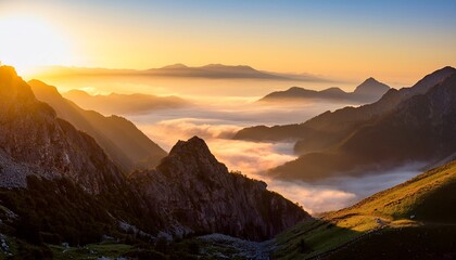 the golden light of the rising sun illuminates the rugged mountains creating a stunning contrast with the misty valleys