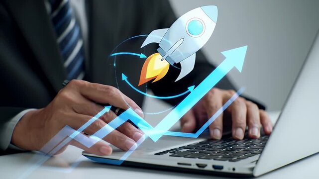 Man Typing on Laptop With Digital Rocket Launch and Arrow Graphics on a White Table in a Business Setting Illustrating Financial Growth