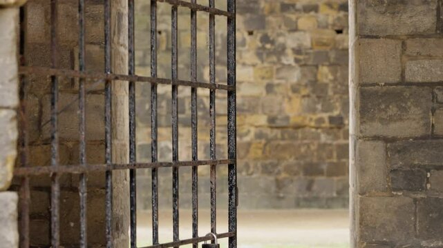 Rusty metal gate is closing access to a courtyard in a historic building