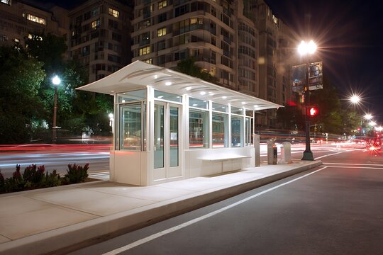 Modern Bus Stop Illuminated at Night with Light Trails, Urban Scene of Public Transportation with Sleek White Shelter and Cityscape Backdrop