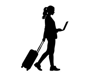 Silhouette of businesswoman working on laptop while walking with suitcase