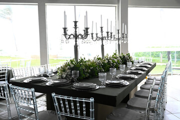 table set in ballroom, elegant wedding reception table with candlesticks, luxury dinner arrangement...
