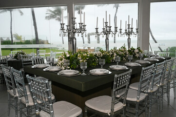 table set in ballroom, elegant wedding reception table with candlesticks, luxury dinner arrangement...