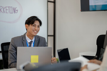 businessman is sitting working in a private office, sales promotion planning staff is writing a...