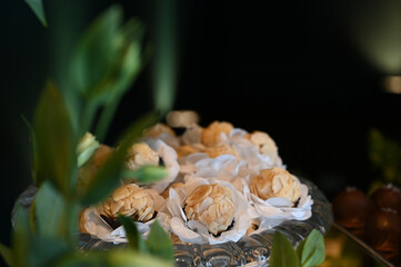 elegant handmade sweets for event, floral-style candy arrangement, artisan treats with delicate wrapping, candy balls,  close up sweets, candy table

