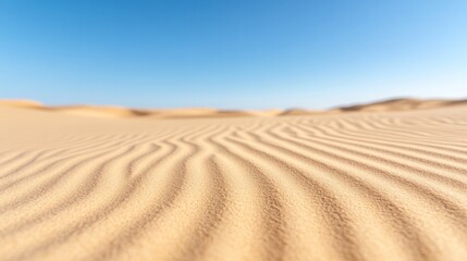 Naklejka premium A serene view of sand dunes under a clear blue sky, showcasing the beauty of nature's simple patterns and tranquility.