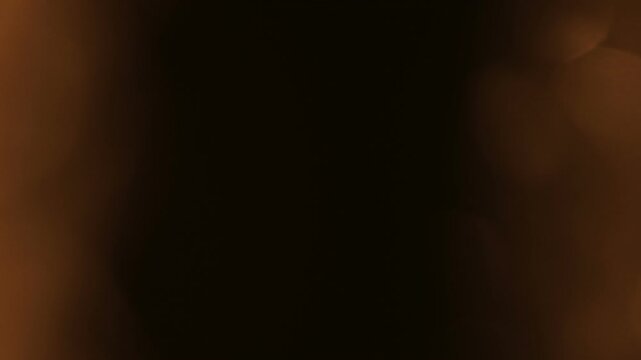 Abstract Amber Light Leaks: Dynamic Bokeh & Dark Transition