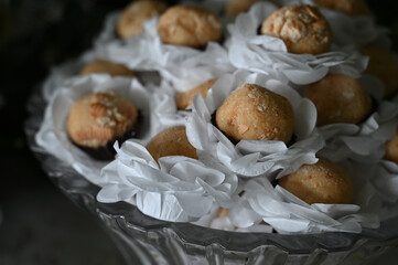 elegant handmade sweets for event, floral-style candy arrangement, artisan treats with delicate wrapping, candy balls,  close up sweets, candy table

