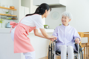リビングで介護をする若い女性介護士