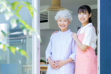 リビングで介護をする若い女性介護士