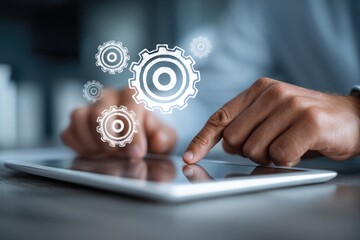 Close-up of hands interacting with a tablet, gears overlayed