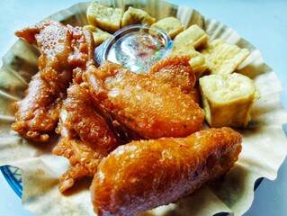 Fried banana cake on a plate on a white background