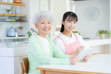 リビングで介護をする若い女性介護士