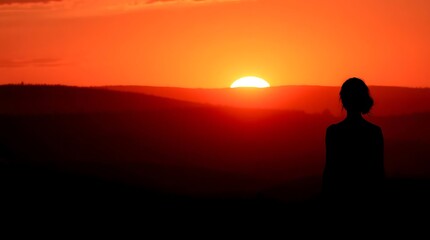 Silhouette gazes at sunsets fiery spectacle