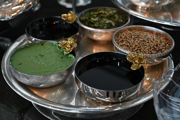 Japanese condiments in metal bowls, sushi accompaniments, silver trays, soy sauce and wasabi...